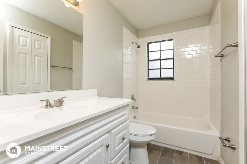 a bathroom with a sink toilet and a bath tub
