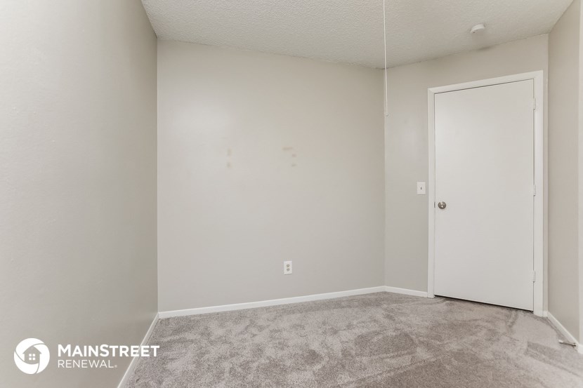 the living room of a manufactured home with a door to the closet