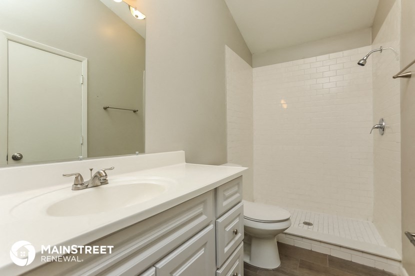 a white bathroom with a sink and a toilet