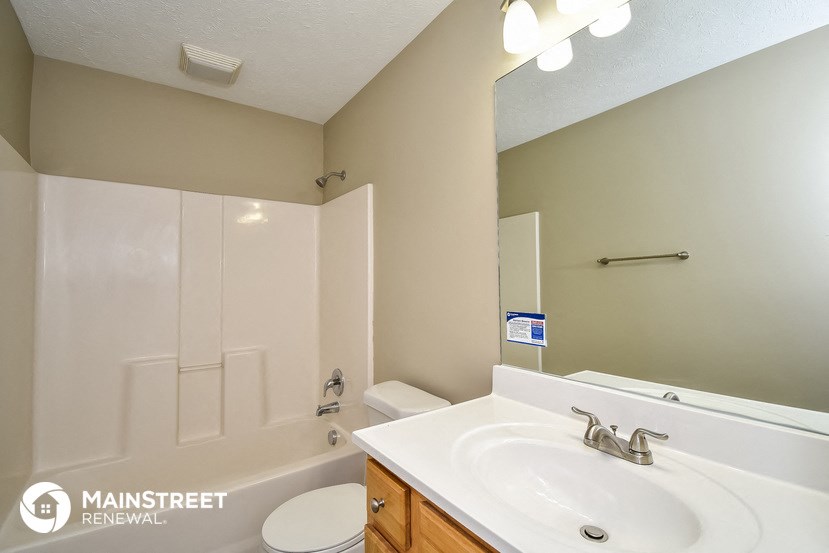 a bathroom with a sink and a shower and a toilet