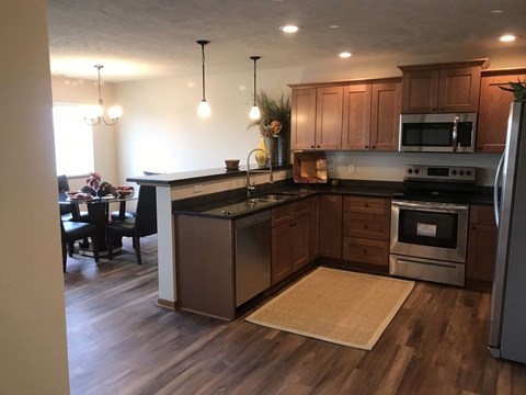a kitchen with wooden cabinets and stainless steel appliances