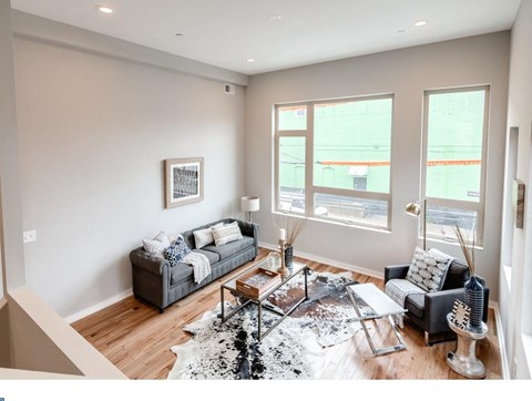 A living room with a grey couch and a coffee table.