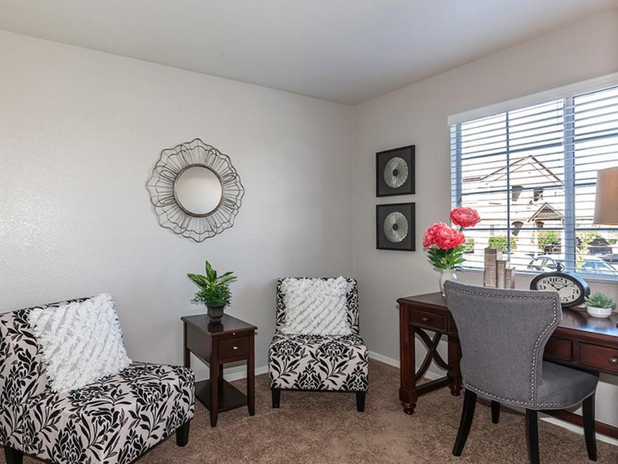 a living room with two chairs and a table