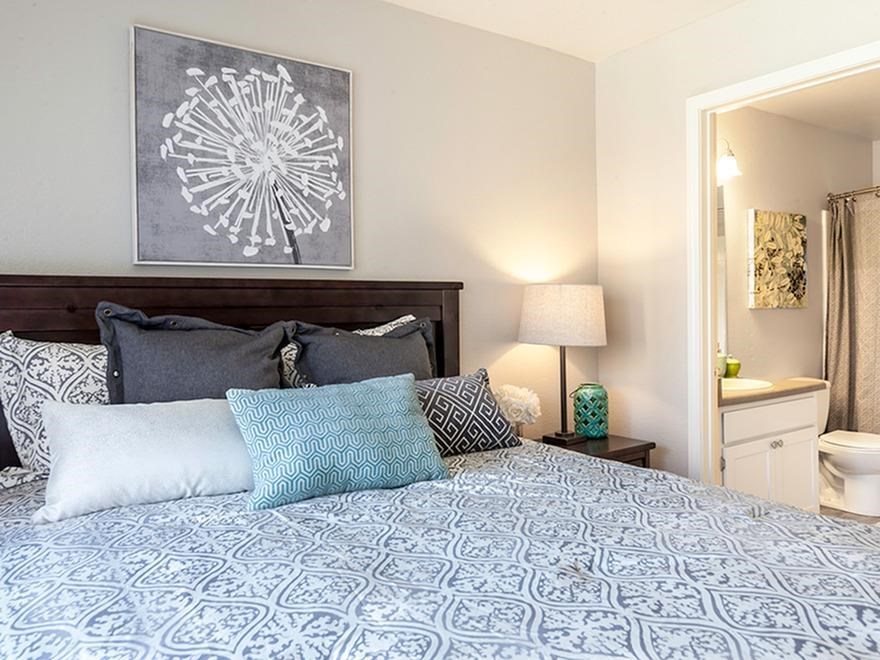 a bedroom with a large bed with pillows on it