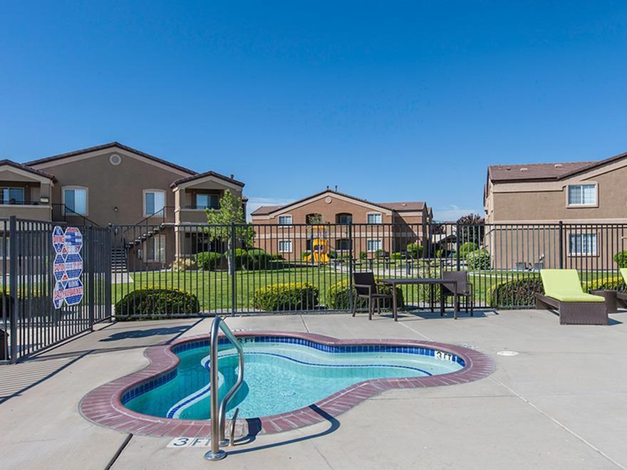 a swimming pool with a wrought iron fence around it