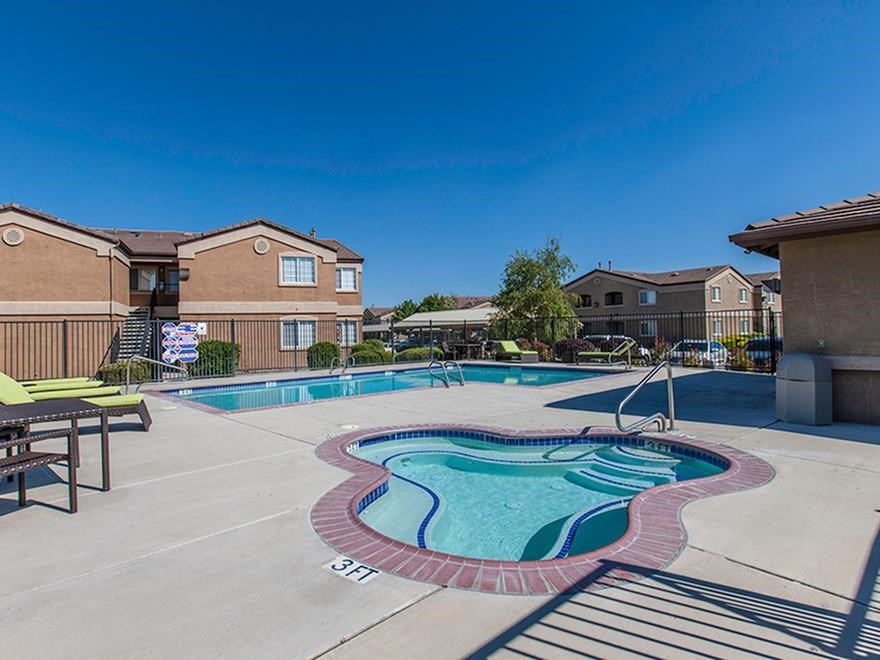 our apartments have a swimming pool and a patio with chairs