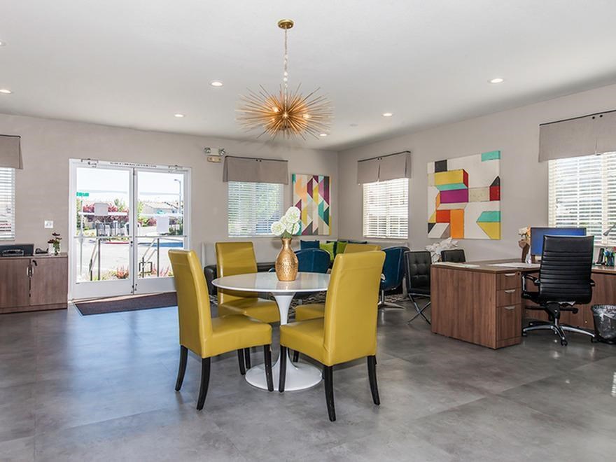 a dining room with yellow chairs and a table