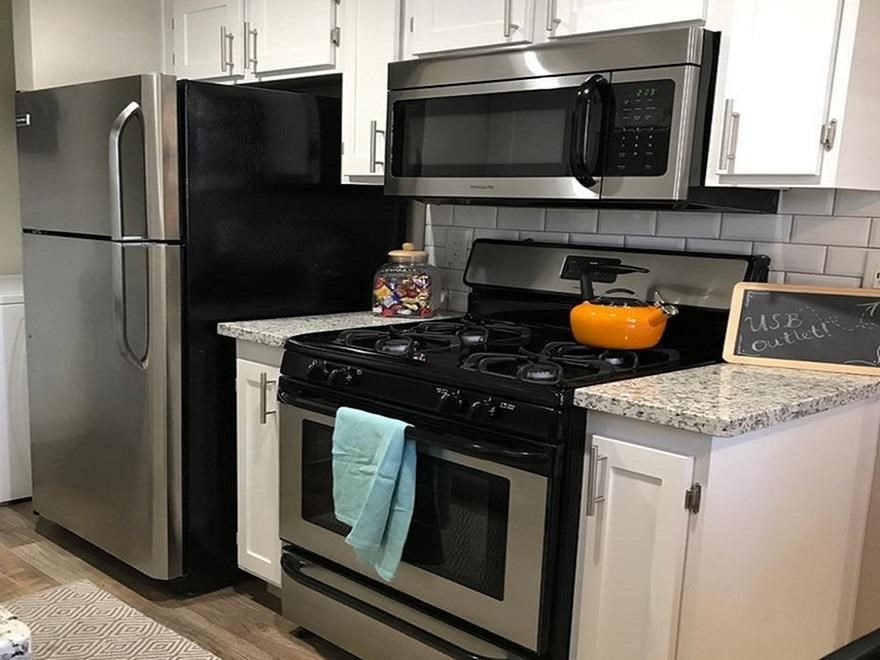 a kitchen with a stove microwave and refrigerator