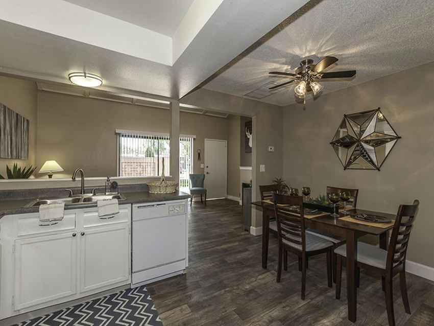 a kitchen and dining room with a ceiling fan