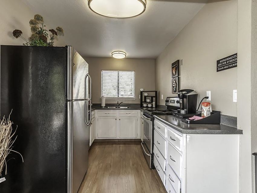 a kitchen with a refrigerator and a sink
