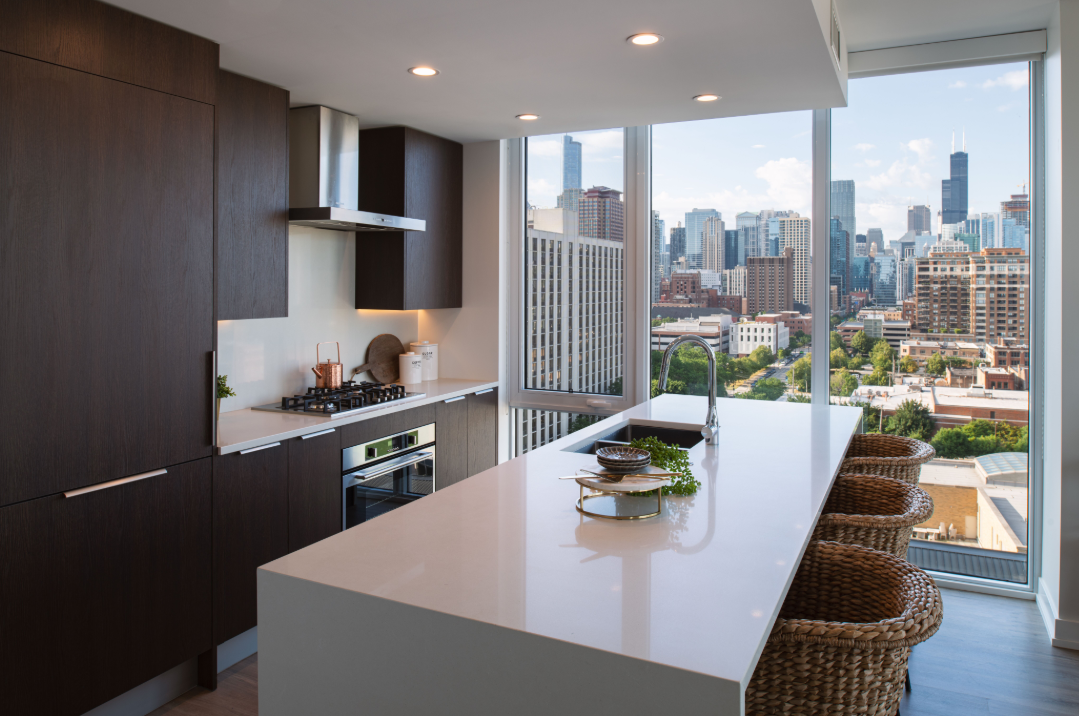 a kitchen with a large island and a view of the city