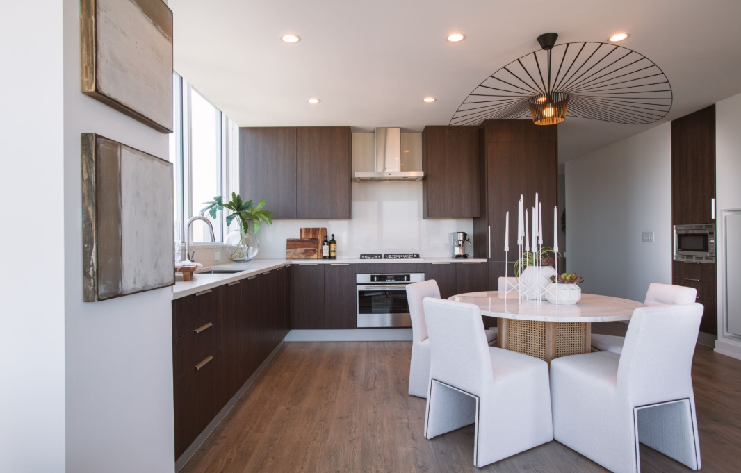 a kitchen and dining room with white chairs and a table