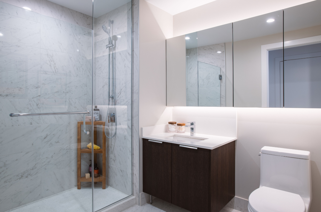 a bathroom with a shower and a sink and a toilet