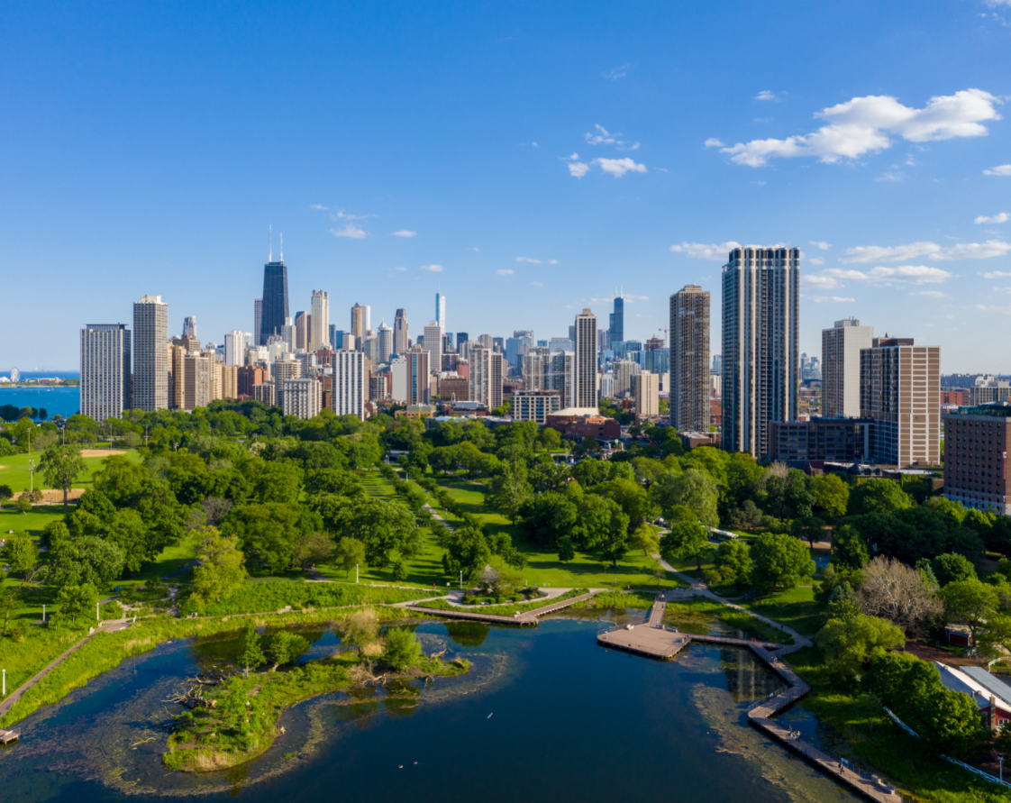 an aerial view of the skyline with a park and a river