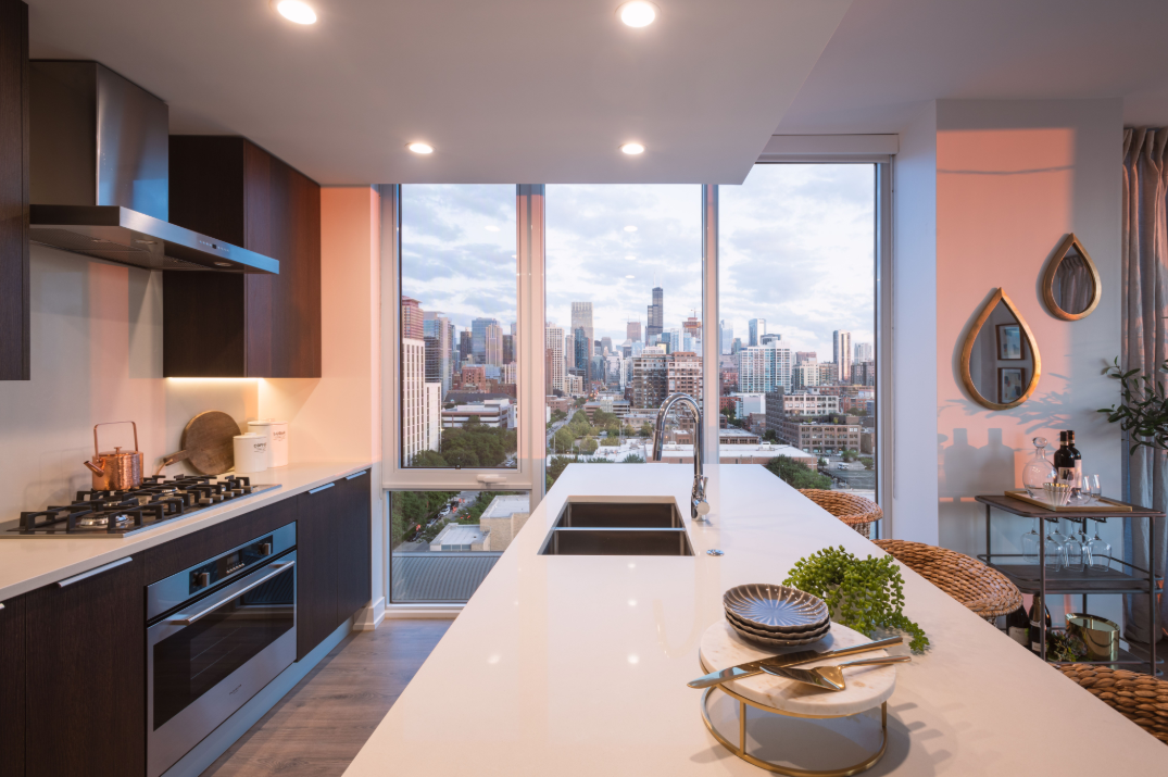 a kitchen with a large window and a city view