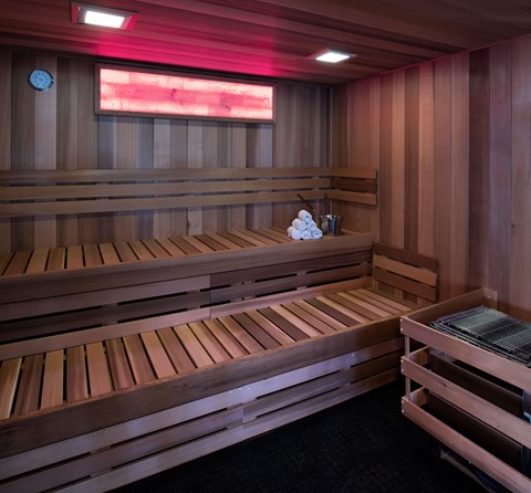 a large wooden sauna with benches and a table
