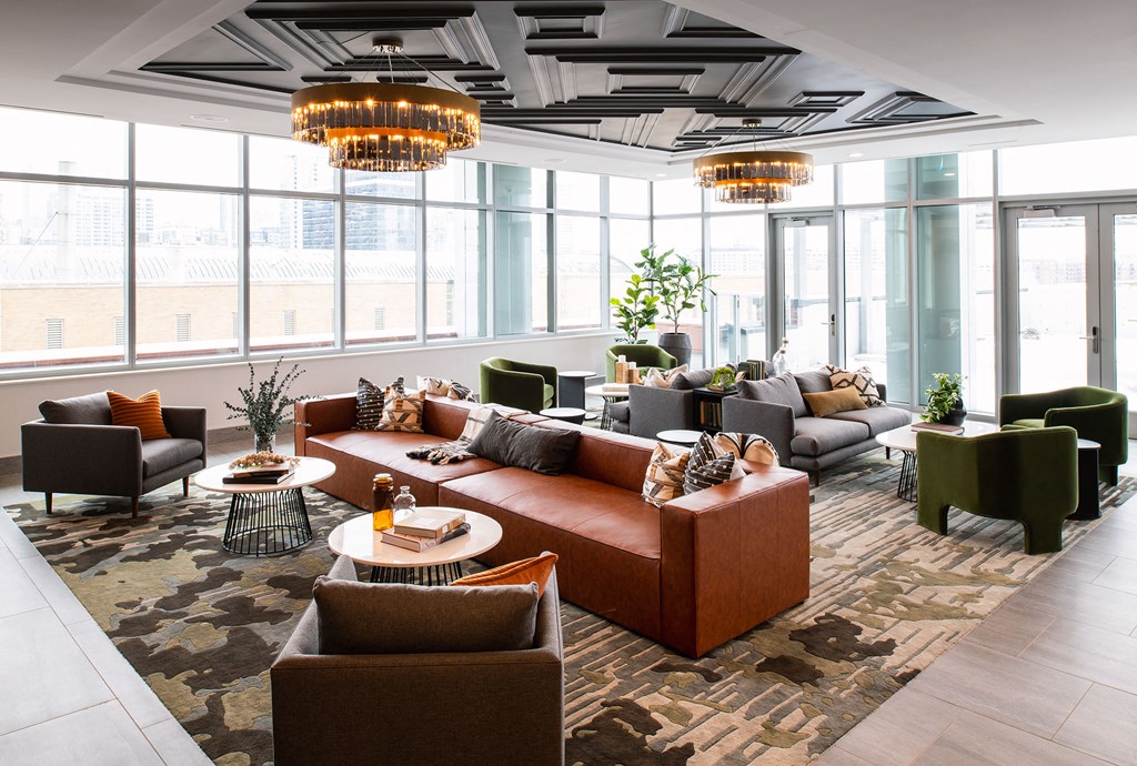 a large living room with couches and chairs and large windows