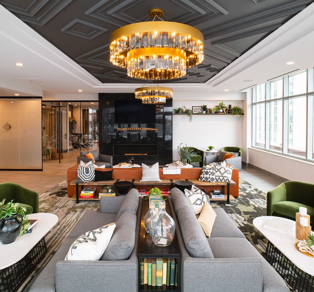 a living room with couches and chairs and a large fireplace