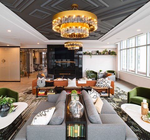 a living room with couches and chairs and a large fireplace