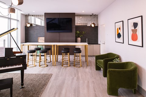 a living room with a bar and a piano