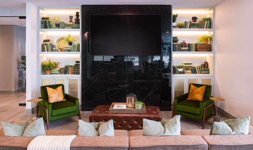 a living room with a couch and chairs and a television