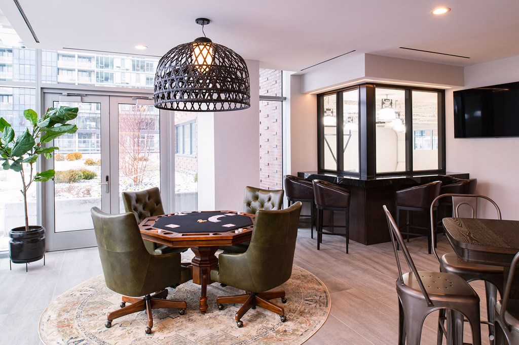 a dining room with a table and chairs and a piano