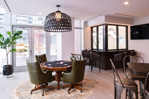 a dining room with a table and chairs and a piano