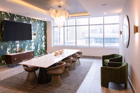 a conference room with a white table and chairs and a large window