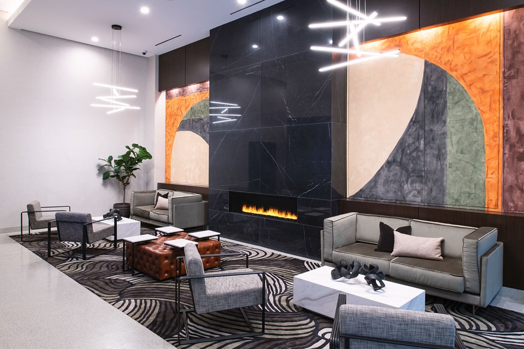 a lobby with couches and chairs and a fireplace