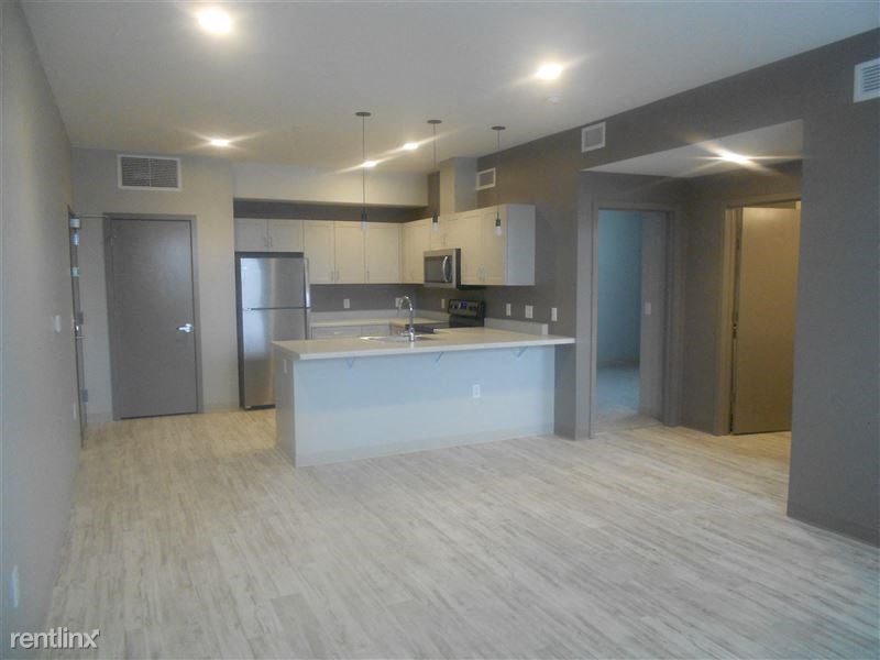 an empty kitchen with an island in the middle