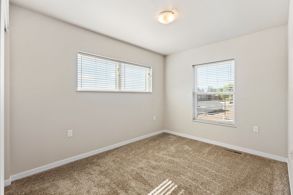 an empty room with carpet and a window