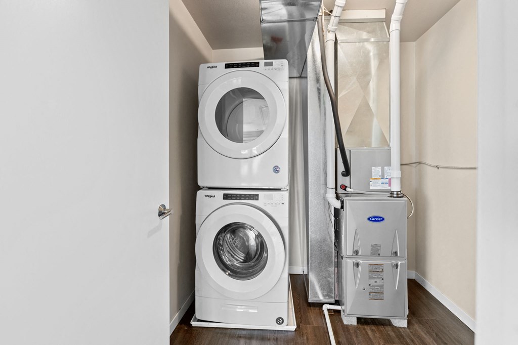 a white washer and dryer in a room with a washing machine