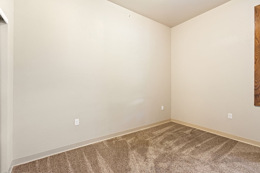 a empty room with carpet and white walls