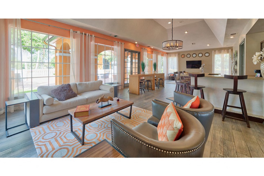 a living room with couches and chairs and a table