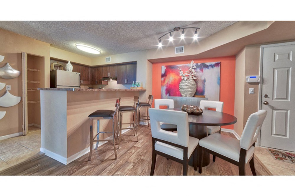 a dining room and kitchen with a table and chairs