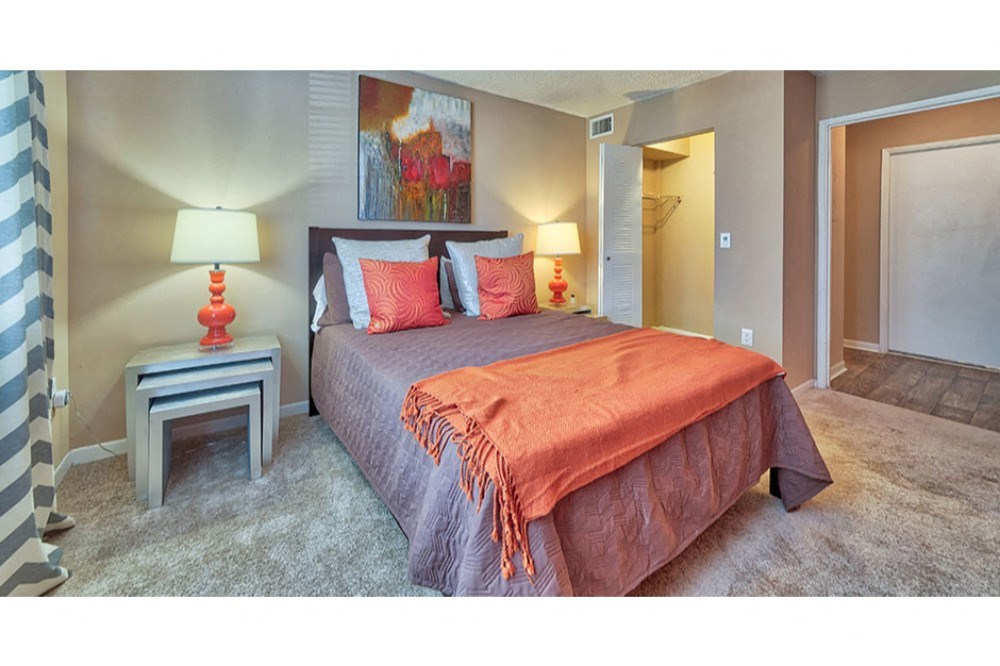 a bedroom with a bed and a closet