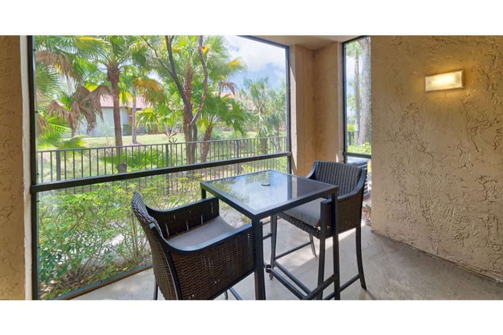 a patio with a table and chairs on a balcony