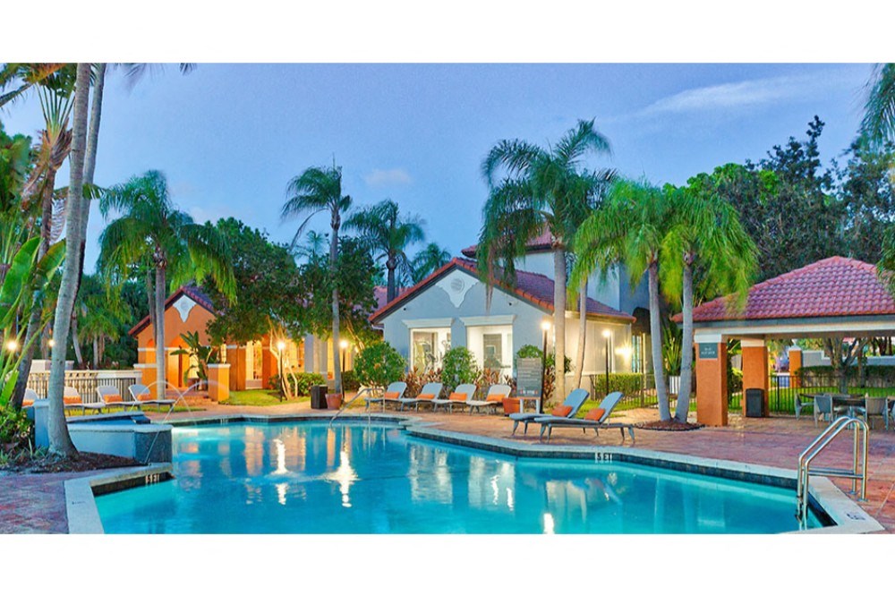 a house with a swimming pool and palm trees