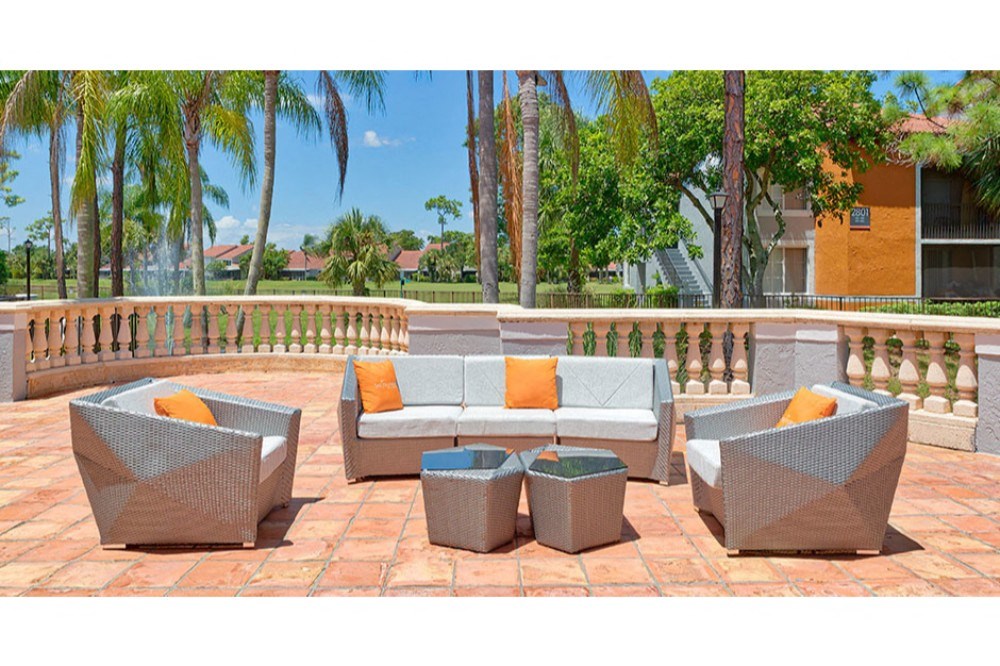 a seating area with couches and tables on a patio