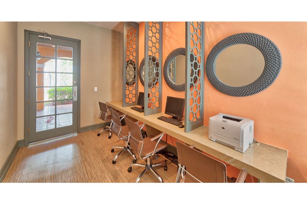 a conference room with desks and chairs and a printer