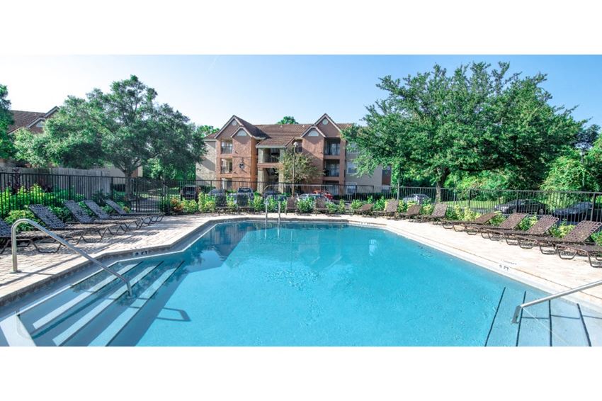 a swimming pool with a house in the background