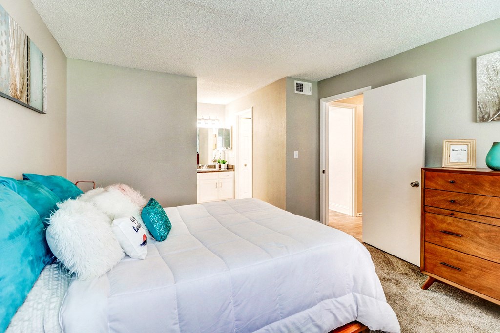 a bedroom with a bed and a dresser