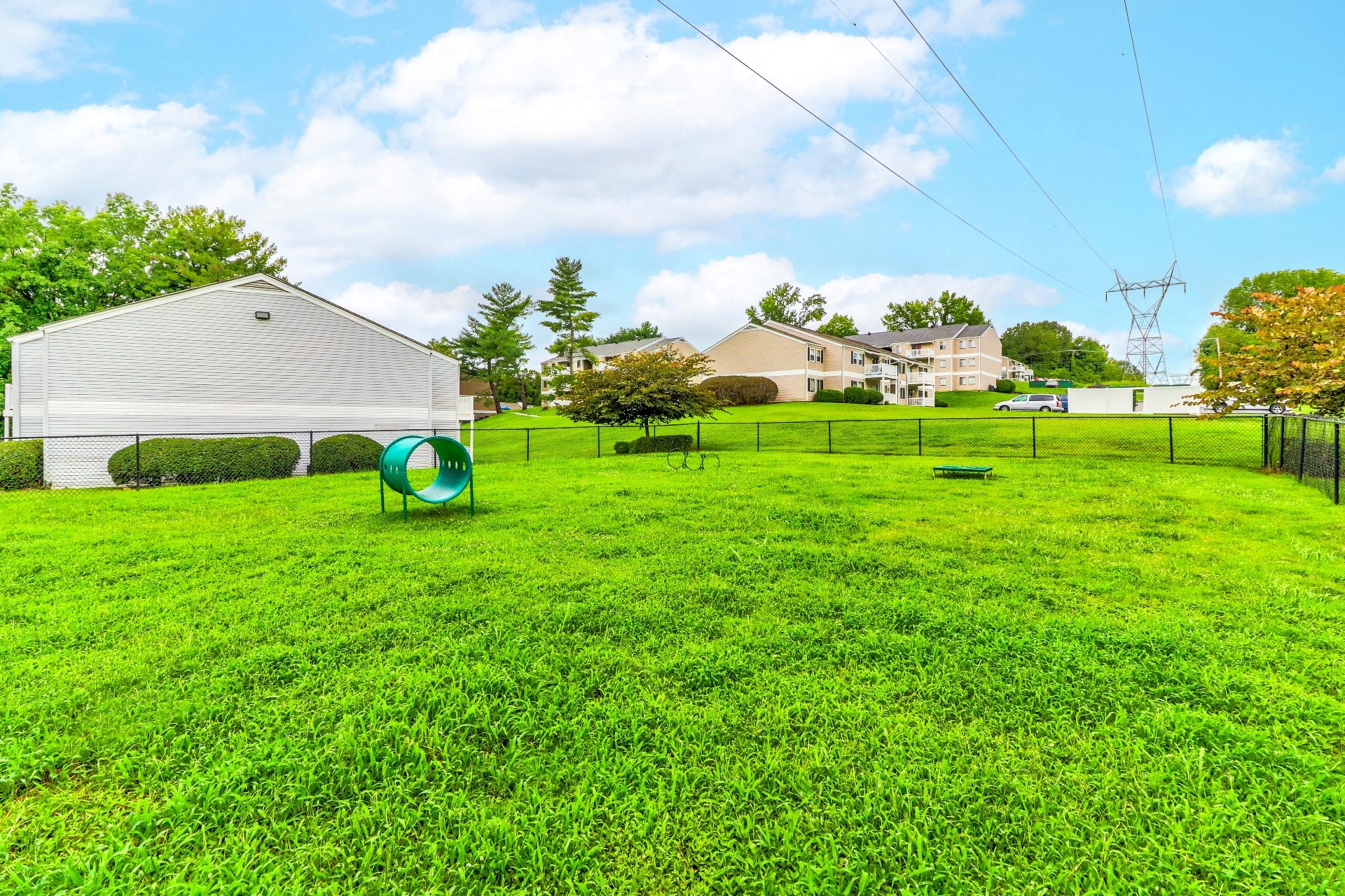 the back yard of a house with a frisbee in the grass
