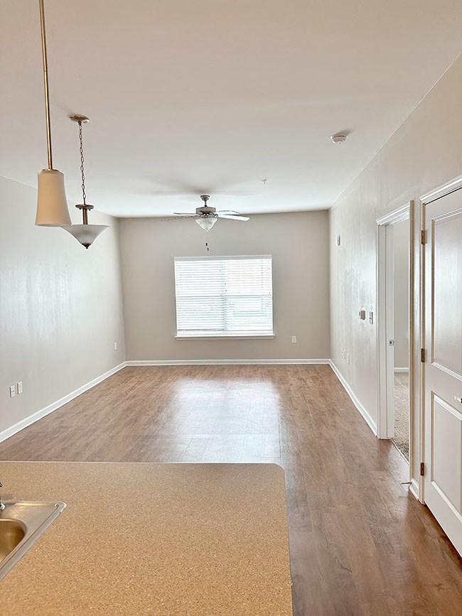 A kitchen with a sink and a fan.