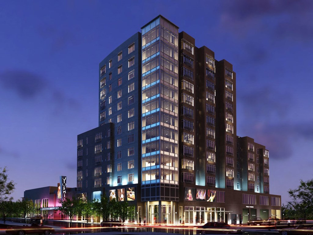 a rendering of a tall hotel at night