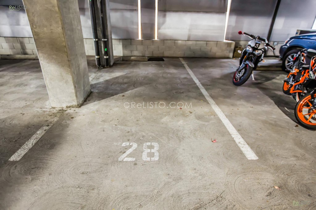a row of motorcycles parked in a parking garage