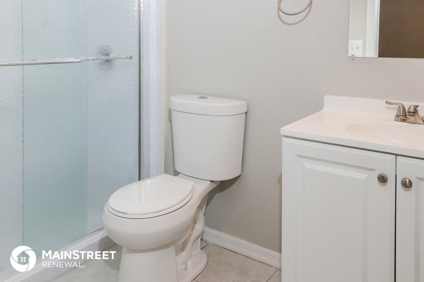 a bathroom with a toilet and a sink and a shower