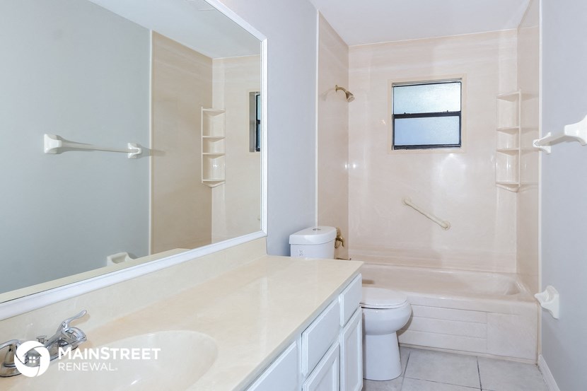 a bathroom with a toilet and a tub and a sink