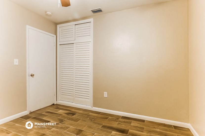 the living room of a house with a closet and a door
