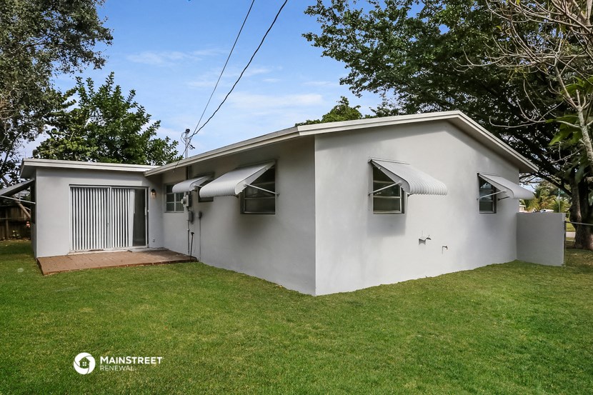 a white house with a yard and a garage